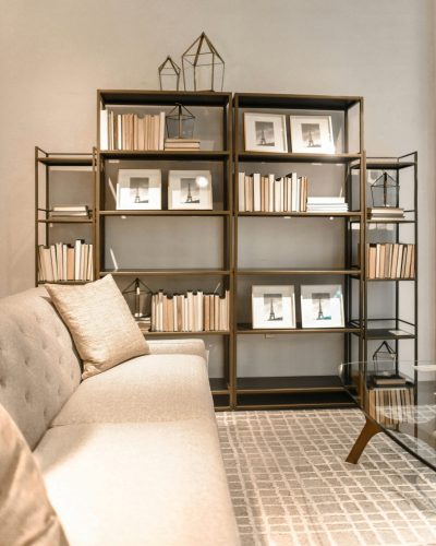 A stylish modern living room featuring bookshelves with decor and a comfortable sofa. Ideal for interior design inspiration.